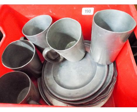 A quantity of assorted pewter plates and five pewter tankards