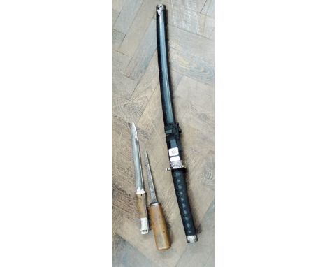 A reproduction Japanese sword in scabbard, German bayonet and one other 