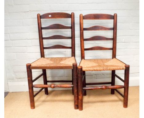 A pair of Lancashire ladder back dining chairs with rush seats 