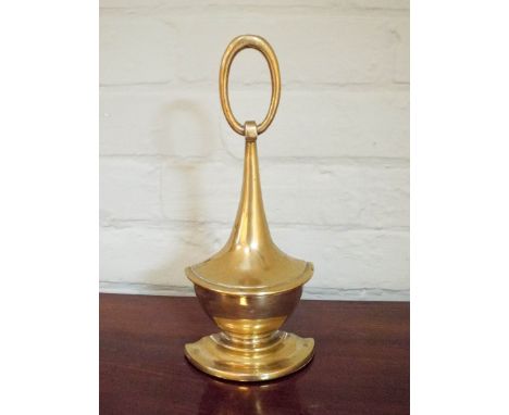 A heavy brass lamp shaped door stop 