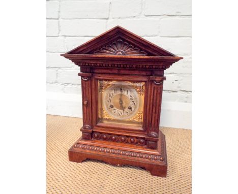 An Edwardian bracket clock in oak case with square brass and silver dial and striking movement, 16" tall, 12" wide 