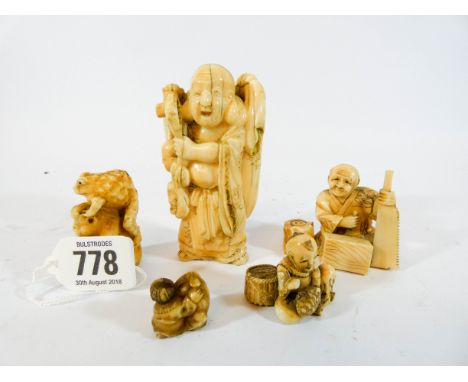 A collection of five Japanese 19th century carved ivory Netsuke to include one of a monkey with toad upon its back, tallest f