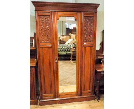 An Edwardian walnut three piece bedroom suite comprising of wardrobe with centre mirror door and carved panels, 3'9 dressing 