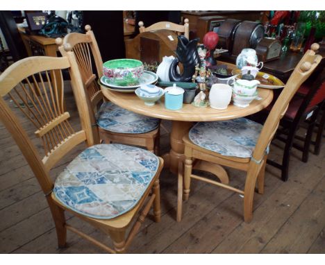 A modern light beech drop leaf kitchen or dining table 3' wide together with four spindle back style chairs with panel seats 