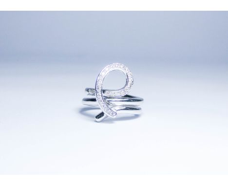 Unusual diamond ring, set in 18ct white gold with a twirl of brilliant cut diamonds on an abstract coiled wide band. Stamped 