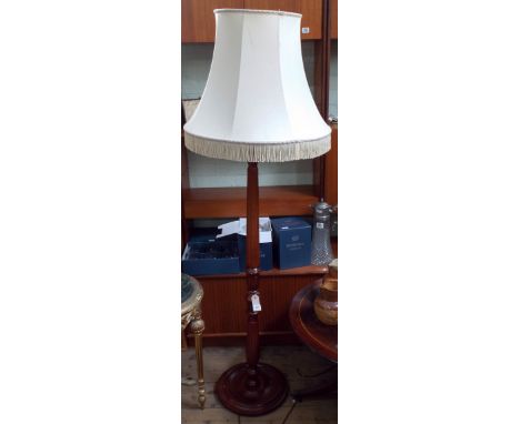 A mahogany standard lamp with reeded column and cream shade 