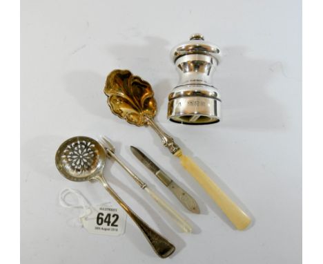 A collection of silver items to include modern silver pepper grinder, gilded bone handled jam spoon, sifting spoon, pickle fo