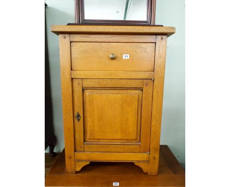 A heavy light oak bedside cabinet fitted with a drawer 