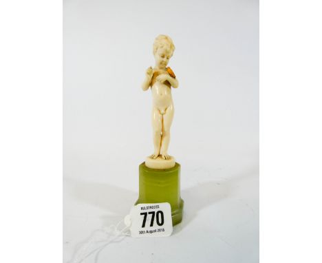 Ferdinand Preiss, Boy with a bird, an Art Deco carved ivory figure circa 1925 on an octagonal section green onyx base signed 