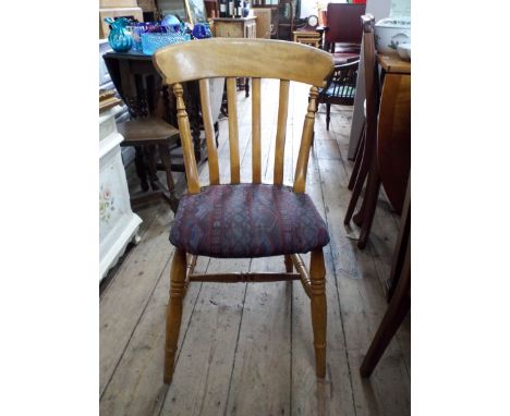 A set of four light beech farmhouse style Windsor dining chairs with upholstered seats 