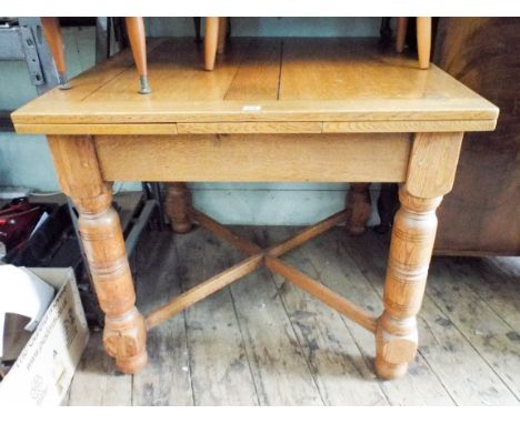 A 3' heavy light oak drawer leaf dining table on turned legs with cross stretchers 