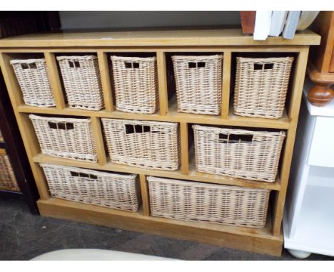 A light oak chest fitted ten wicker drawers 