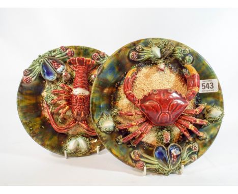 A pair of Sarreguemines relief moulded naturalistic wall plaque depicting a crab and a lobster, impress marks on reverse, 23c