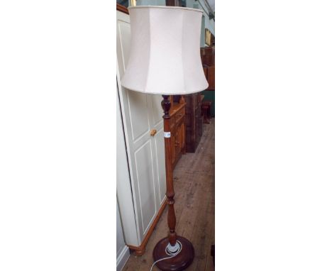 A mahogany standard lamp with reeded column together with a cream shade 