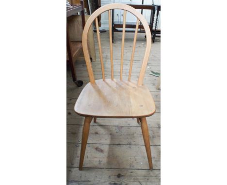 A pair of Ercol light wood stick back Windsor dining chairs 