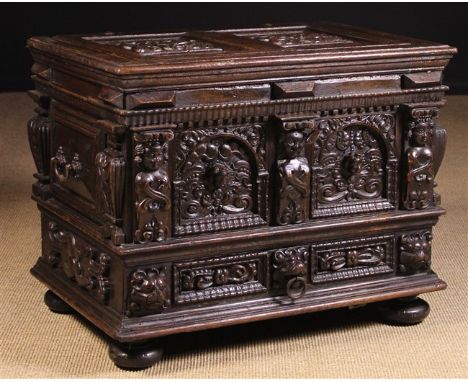 A Small 17th Century Style Oak & Walnut Coffer. The twin panel lid and arcaded front richly carved with heraldic crests, prot