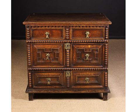 A Small William & Mary Oak Cushion Front Chest of Drawers with geometrical mouldings. The three long drawers hung on side gro