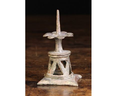 A Small Medieval Copper Alloy Pricket Stick, possibly 15th century. The spike centring a petalled flower head platform above 