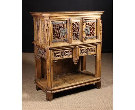 A 15th Century & Later French Dressoir intricately pierced and carved with Gothic tracery backed in red velvet and having cro
