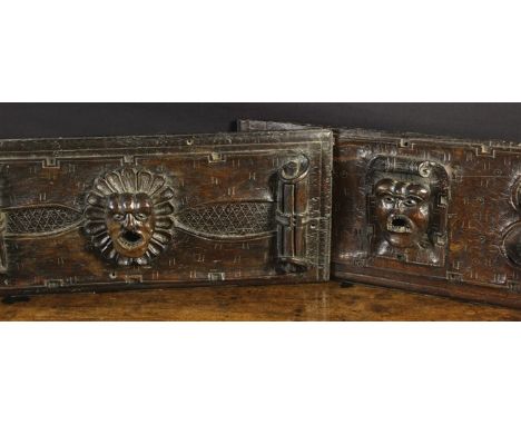 A Pair of Fine and Rare 16th Century Oak Panels. Each panel carved in relief with a gapping face-mask protruding from the cen