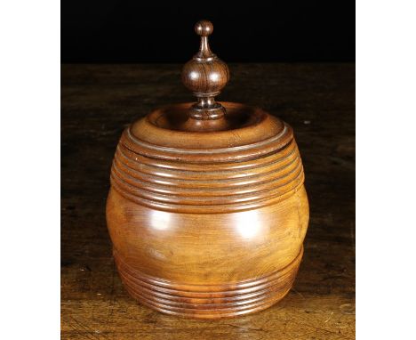 A 19th Century Turned Treen Tobacco Jar. The round moulded lid surmounted by a rosewood finial with a lead inner lid. The squ