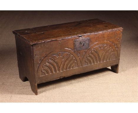 A Small 17th Century Boarded Oak Coffer of good colour and patination. The twin plank lid on iron strap hinges opening to rev