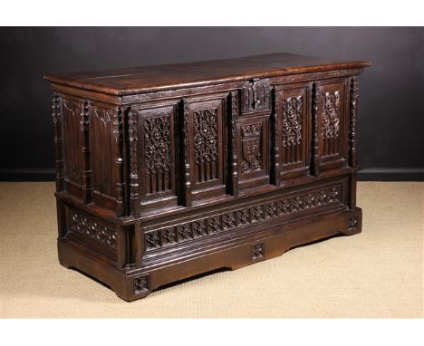 A French 16th Century & Later Gothic Coffer. The facade enriched with tracery in four panels flanking a small central armoria