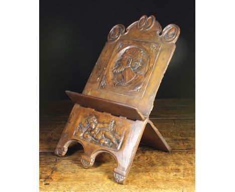 A Folding Walnut Book Rest constructed from one piece of timber and carved with a Romayne portrait of turbanned man above a r