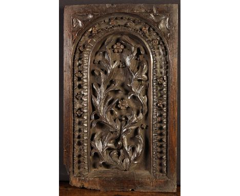 A Fine Arcaded Panel Circa 1700, deeply carved with rising sprays of acanthus dotted with small flower heads and whorls frame