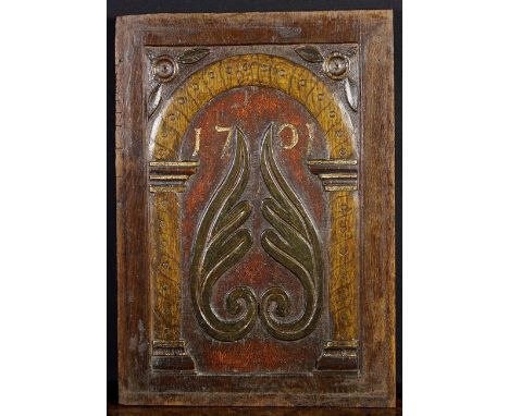 A Rare Polychromed Oak Panel, attributed to Yorkshire, carved with a pair of foliate plumes beneath a simple gadrooned arch, 