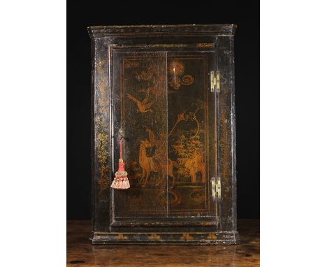 A Georgian Lacquered Hanging Corner Cupboard. The panel door with applied edge moulding, decorated with a Chinoiserie scene a