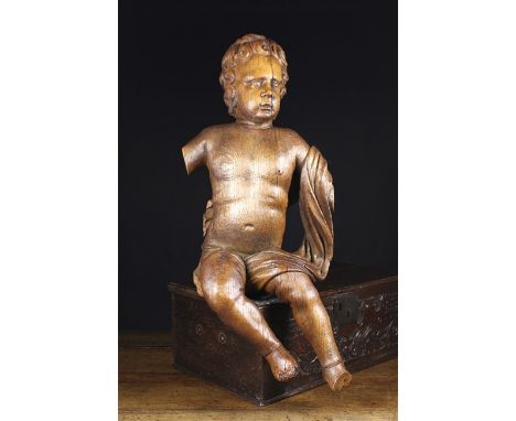 A Large Late 17th Century Flemish Carved Oak Cherub. The  figure with hollowed back carved in-perspective to be viewed elevat