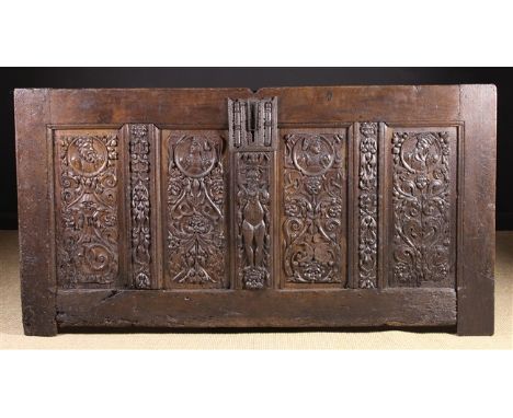 A 16th Century French Panelled Oak Coffer Front. The four panels richly carved with Romayne portrait roundels above stems of 