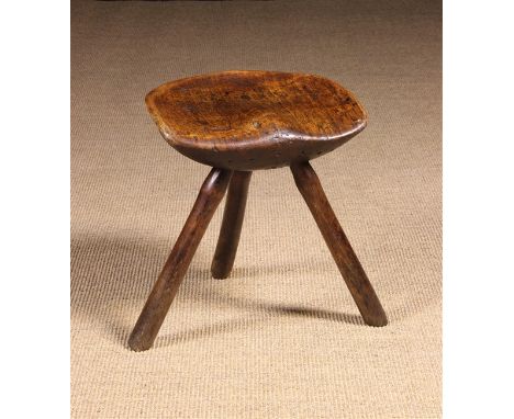 A Rustic Saddle Seat Stool  on splayed stick legs 16½ ins (42 cms) high, 15 ins x 12 ins (38 cm x 31 cms).