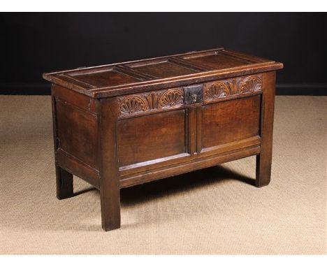 A Small Late 17th/Early 18th Century Joined Oak Coffer. The triple panel lid on staple hinges above a lunette carved frieze r