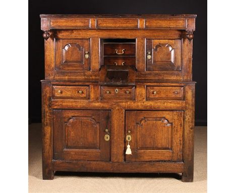 A Fine 18th Century Joined Oak Deuddarn with secret compartment. The upper section having a canopy frieze with turned pendant