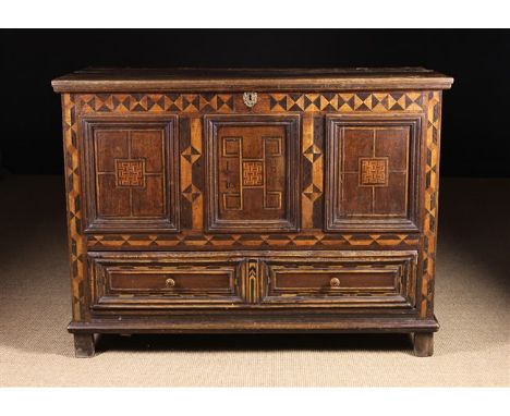 A 17th Century Oak & Parquetry Mule Chest.  The moulded triple panel front inlaid with geometric designs; the centre panel in
