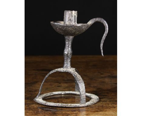 An 18th Century Wrought Iron Candlestick. The candle socket with open side centring a dished drip pan with handle above a kno