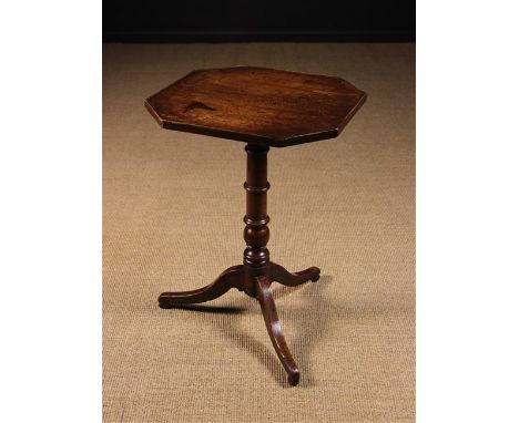 A Late 18th Century Oak Tripod Table. The octagonal top edged in cock-beading and standing on an astrigal ringed and ball kno