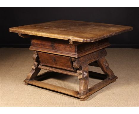 A 17th/18th Century Money Changers or Rent Table. The thick planked near square top having rounded corners above a splayed du