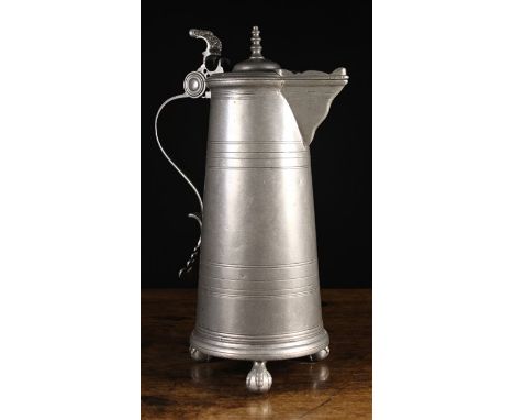 A Large 19th Century Pewter Laver. The hinged lid with heart shaped spout, spire finial and scroll thumb-piece ornately cast 