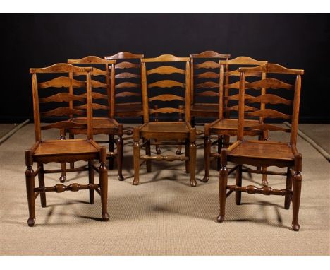 A Set of Seven Ash & Elm Ladder backed Side Chairs, Circa 1800. The dome topped cresting rails surmounting turned uprights ab