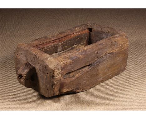 A Rustic Dug-out Trough, possibly medieval. The thick rectangular block having a slab cap to one end with carved loop handle,