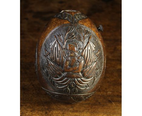 A 19th Century Carved Coconut Shell with oval panels depicting a portrait of Napoleon, his tomb, and an eagle with a snake in