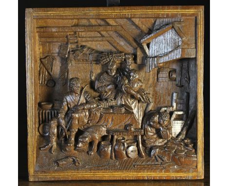 A 19th Century Relief Carved Panel. The 3½ inch (9 cm) thick panel having recessed carving depicting a domestic scene with fi