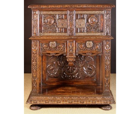 A Renaissance Style Walnut Dressoir lavishly carved throughout with portrait medallions, zoomorphic scrolls and foliage. The 