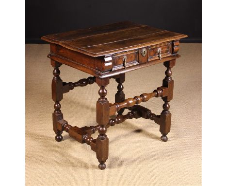 A Late 17th Century Joined Oak Side Table. The top with moulded edge above a twin panel drawer with ornate cast brass drop ha