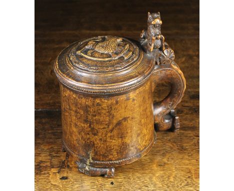 A Fine 18th Century Norwegian Birch Peg Tankard. The domed lid carved in relief with a lion and hinged to the handle with a l