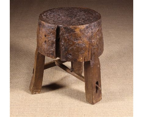 A Rustic Grinding Block, probably 19th Century. The 10½ ins (27 cms) thick tree trunk section with circular top inset with me