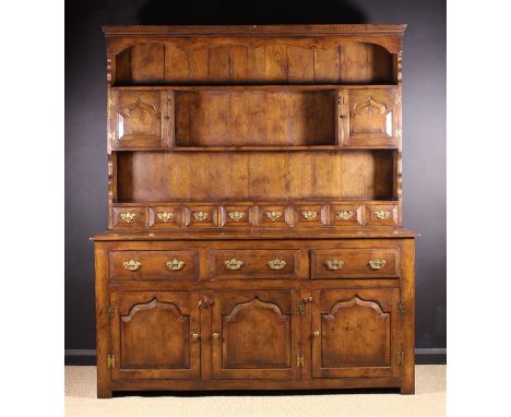 A Good Quality Reproduction 18th Century Style Oak Welsh Dresser. The rack having a shaped frieze rail above three shelves wi